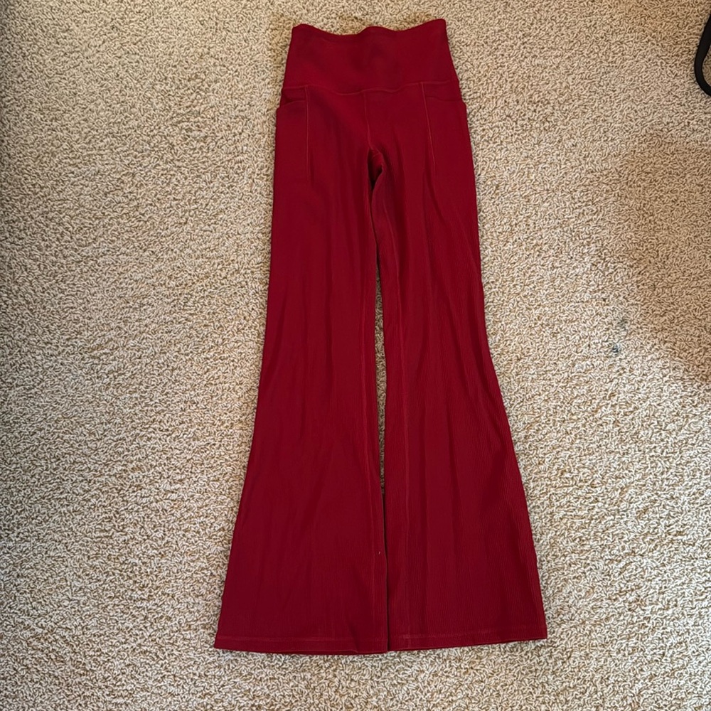 Red, ribbed athleta leggings. Size extra small. Pockets on both sides.